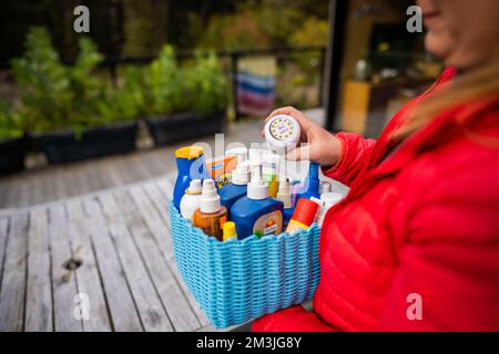 container of sunscreen, buy spray and summer lotions in summer australia in spring Stock Photo