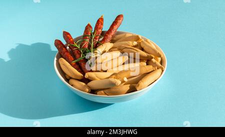 Spanish mini chorizo and picos on blue Stock Photo
