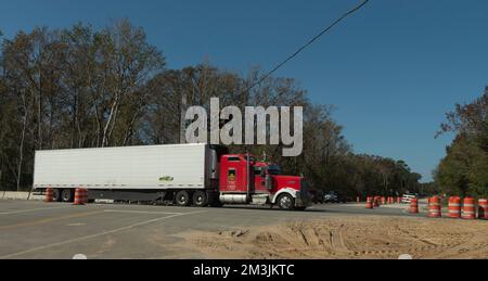 DeLand, Florida USA.  2022. Red and white truck on the West New York Ave, passing through roadworks on the state road 44. Stock Photo