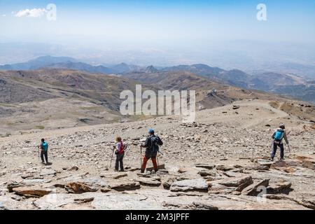 A group of hikers exploring the Sierra Nevada mountain range at Pico Veleta in Andalusia, Spain Stock Photo