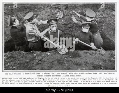 British soldiers wearing respirators while digging a trench to guard against fumes from bursting shells. The Germans first used poison gas at Ypres on 22nd April 1915. Stock Photo