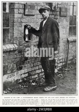 Staffordshire miner handing in his lamp before the October 16 coal strike. About one million miners went on strike in aid of wage increases. Stock Photo