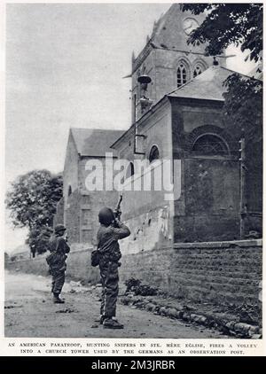 American paratroop, hunting snipers in St. Mere Eglise, firing a volley into a church tower, used by German soldiers as an observation post. Photograph was taken in the Normandy battle zone, shortly after the 'D-Day' landings on 6th June 1944. Stock Photo