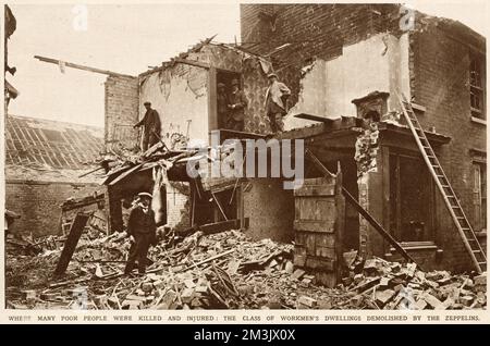 On the night of the 31st January 1916, Zeppelins of the German Navy attacked the Midlands causing extensive damage. Air raid sirens were used for the first time to warn the civilian population of the incoming aerial attack. Police ensured that a black-out was in place. Workmen stand in the rubble. Stock Photo