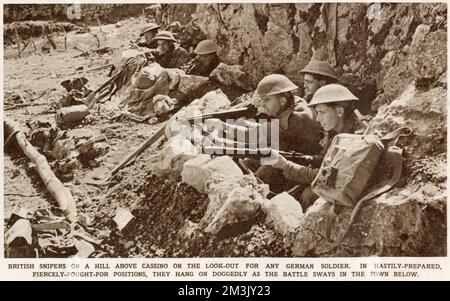 A group of British soldiers dug in to a position near Monte Cassino, Italy, in 1944.  Between January and May 1944 the Benedictine monastery of Monte Cassino and the nearby town were completely destroyed as the Allied Fifth Army attempted to push the occupying Nazi troops out of their strong defensive position, in the monastery. Stock Photo