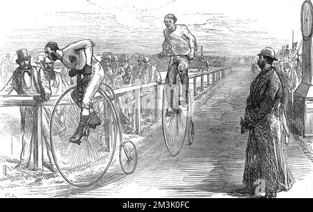 Race between G.P. Whiting (left) and G.N. Keith-Falconer, the best two amateur bicycle riders of the day, over a course of 25 miles at the Lillie-Bridge grounds, London, January 1875. Whiting won the race by 11 seconds, in a little over 1 hour and 41 minutes, to claim a 20 prize Silver Cup. Both cyclists were riding 'Penny Farthing' or 'Ordinary' bicycles, which were most popular between 1871 and 1885.  1875 Stock Photo