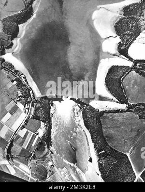 Aerial photograph showing the Mohne Dam and reservoir (top) after the 'Dambusters' raid of 1943.   On the 16th May, 'Lancaster' bombers of 617 Squadron, led by Guy Gibson, attacked four dams in the Westphalia region of Germany. They breached two, the Mohne and Eder dams, leading to widespread flooding.     Date: 1943 Stock Photo