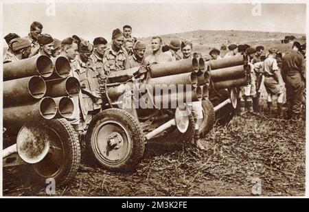 Allied soldiers inspecting captured German 'Nebelwerfer' guns in Tunisia, North Africa. The 'Nebelwerfer' was a six-barrelled mortar on a mobile carriage, designed to saturate a small target area with gas, smoke or high-explosive rockets. Stock Photo