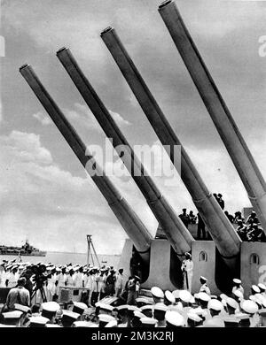 Admiral Chester Nimitz, the US Pacific Commander, addressing the crew of HMS 'King George V', whilst standing under the guns of the Royal Navy battleship, June 1945.     Date: 1945 Stock Photo