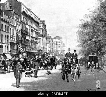 Horse-drawn carriages travelling along Piccadilly, during the London 'Season'. Stock Photo
