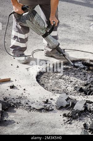 hydraulic hammer in the hands of an operator in uniform works the ...