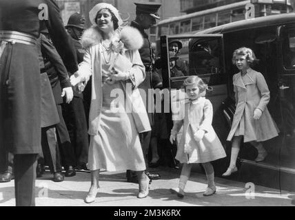 Queen Elizabeth (later, the Queen Mother) with Princess Elizabeth (now Queen Elizabeth II) and Princess Margaret arriving for the Royal Tournament at Olympia in 1935.     Date: Stock Photo