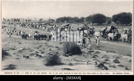 A long column of refugee Sikh flee East Punjab to safety in Pakistan following the violent sectarian aftermath of the partition of India   1947 Stock Photo