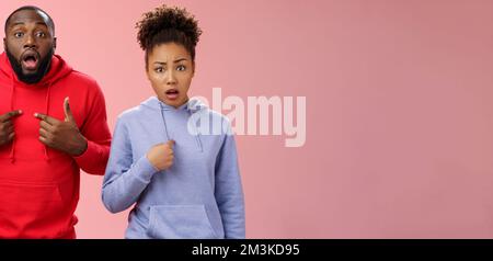 Guys accused feel shocked upset. Portait confused frustrated worried two african-american siblings pointing chest index fingers questioned hear blame Stock Photo