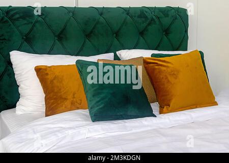 Small decorative colorful plush pillows on the bed Stock Photo