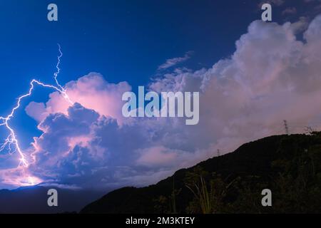 Night clear sky with thunder and lightning lightning. Blue sky, white clouds and lightning. Feicui Reservoir, Shiding District, New Taipei City. Taiwa Stock Photo