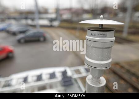 Shallow depth of field (selective focus) details with a PM 10 particle sensor on a heavy traffic street during a rainy day. Air quality concept. Stock Photo
