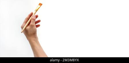 Woman right hand holding paintbrush isolated on white background Stock Photo