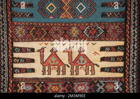 Colorful Oriental Mosaic Carpet With Traditional Folk Animal Ornament. Patterned Carpet. Part Of Oriental Carpet. Closeup Picture Of Handmade Woven Stock Photo