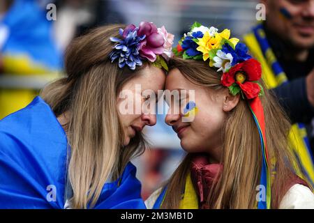 File photo dated 05-06-2022. Ukraine fans share an emotional moment in the stands ahead of their country's World Cup qualifying play-off final against Wales in June in Cardiff. The sporting world showed solidarity with Ukraine in the aftermath of the Russian invasion. Wales clinched the spot in Qatar after a Gareth Bale goal earned a 1-0 win. Issue date: Friday December 16, 2022. Stock Photo