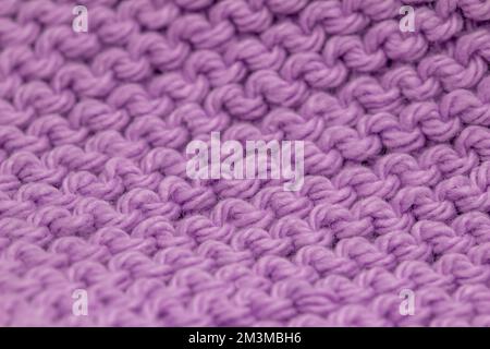 Defocused macro abstract texture background of a hand-knitted lavender pink color cloth in a garter stitch pattern Stock Photo