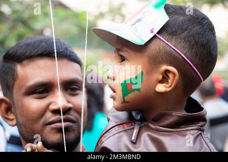 Narayanganj, Dhaka, Bangladesh. 16th Dec, 2022. A Bangladeshi child with a national flag painted on the face to celebrate the 52nd Victory Day, which marks the end of a bitter nine-month war of independence from Pakistan, in Narayanganj, Bangladesh. Bangladesh is celebrating the 52nd anniversary of its national victory, remembering the valiant freedom fighters who fought and made the ultimate sacrifice to free the country from the Pakistani forces. People from all walks of life gather at the Narayanganj Central Shaheed Minar in the morning to mark the most precious day of the Bangali people Cr Stock Photo