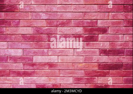 pattern of decorative pink slate stone wall surface as a background. toned in viva magenta, trend color of the year 2023 Stock Photo