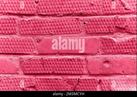 background of pink textured relief brick. aged old stone wall or street texture blocks backdrop closeup. pattern architecture construction design. ton Stock Photo