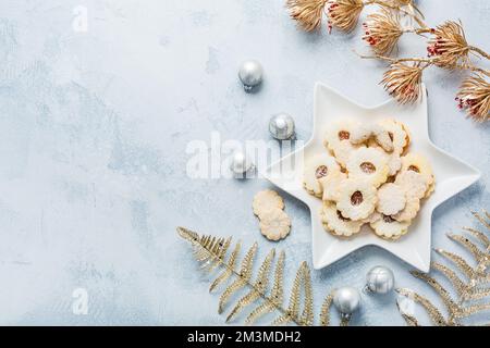 Homemade Christmas cookies and ornaments on kitchen table with copy space Stock Photo