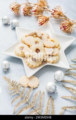 Homemade Christmas cookies and ornaments on kitchen table Stock Photo