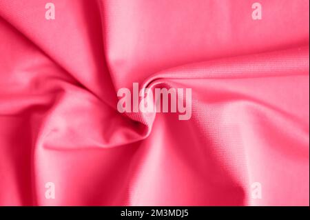 microfiber fabric pink color background with pleats, top view. toned in viva magenta, trend color of the year 2023 Stock Photo