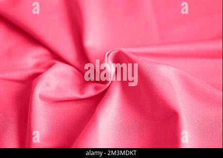 microfiber fabric pink color background with pleats, top view. toned in viva magenta, trend color of the year 2023 Stock Photo