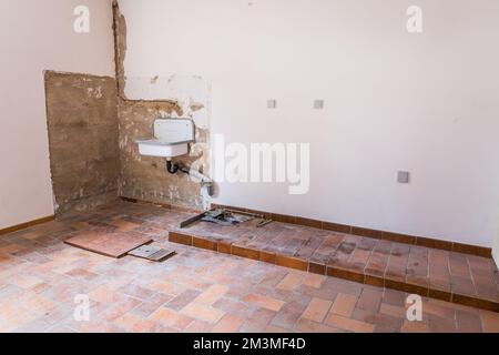Renovation of old house, old washroom under construction under construction with rubble, old bathroom sink and tiles Stock Photo