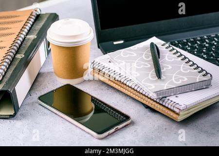 Modern office desk table with laptop, smartphone and other supplies with cup of coffee Stock Photo