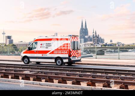 29 July 2022, Cologne, Germany: Ambulance Red Cross van rushes through the streets of the Koln city. Stock Photo