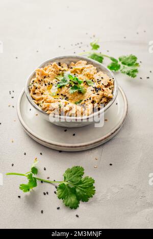 Middle Eastern delicious dip 'Baba Ghanoush' or 'Baba Ghanouj'. It is tasty appetizer made with roasted eggplant, fresh garlic, lemon juice and tahini Stock Photo