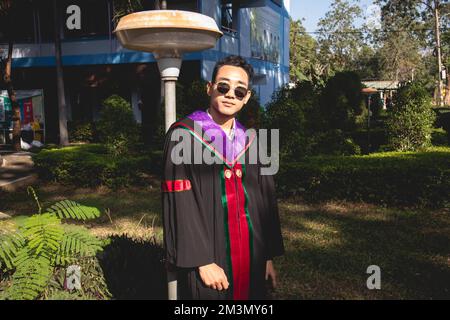 The graduate wore a gown from a university in Thailand. For graduation Stock Photo