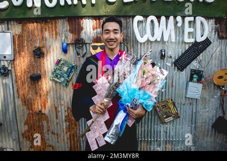 The graduate wore a gown from a university in Thailand. For graduation Stock Photo