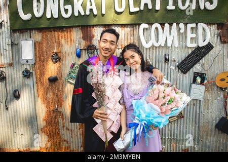 The graduate wore a gown from a university in Thailand. For graduation Stock Photo