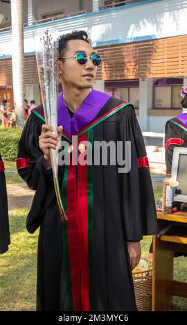 The graduate wore a gown from a university in Thailand. For graduation Stock Photo