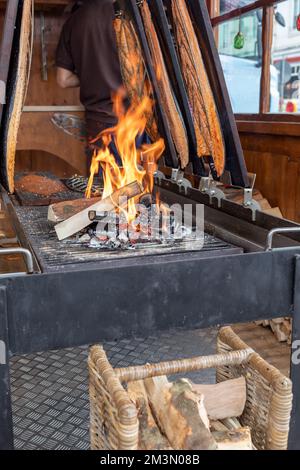 salmon sides are grilled over an open fire Stock Photo