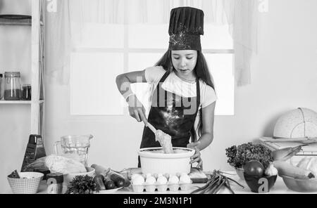 Various menus. kid cooking food in kitchen. choosing a career. little helper baking. culinary and cuisine. happy childhood. happy child wear cook Stock Photo