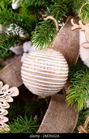 Natural Christmas tree ornament bauble made from beige and white jute rope Stock Photo