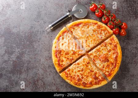 Homemade Greasy New York Cheese Pizza Ready to Eat closeup on the board on the table. Horizontal top view from above Stock Photo