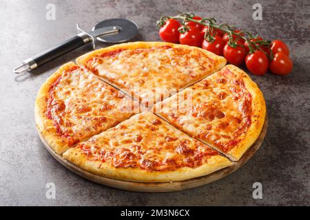 Homemade Greasy New York Cheese Pizza Ready to Eat closeup on the board on the table. Horizontal Stock Photo