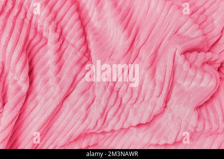 Soft fleece throw fabric with lines in trendy color of the year 2023 Viva Magenta. Texture for cozy winter background Stock Photo