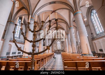 28 July 2022, Essen, Germany: candleholder and Majestic ceiling view in the interior of a gothic church or cathedral Dom Minster Stock Photo