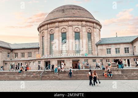 28 July 2022, Cologne, Germany: People at the entrance Deutsche Bahn Hauptbahnhof railroad station entrance. Main Railway station transport terminal i Stock Photo