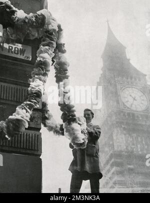 In the shadow of Big Ben, a building is decorated near Parliament Square in readiness for the passing wedding procession of the Duke of Kent and Princess Marina of Greece.  The couple married at Westminster Abbey on 29 November 1934.     Date: 1934 Stock Photo