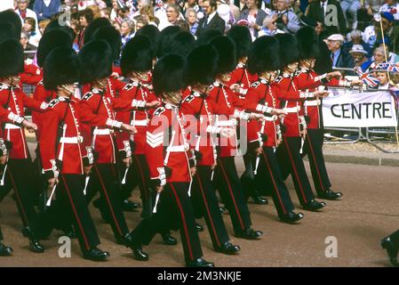 Guards in their famous bearskin helmets march in formation in the procession for the royal wedding between Prince Andrew, Duke of York and Sarah Ferguson who married on 23 July 1986 at Westminster Abbey. These Foot Guards are from the Scots Guards regiment.  1986 Stock Photo